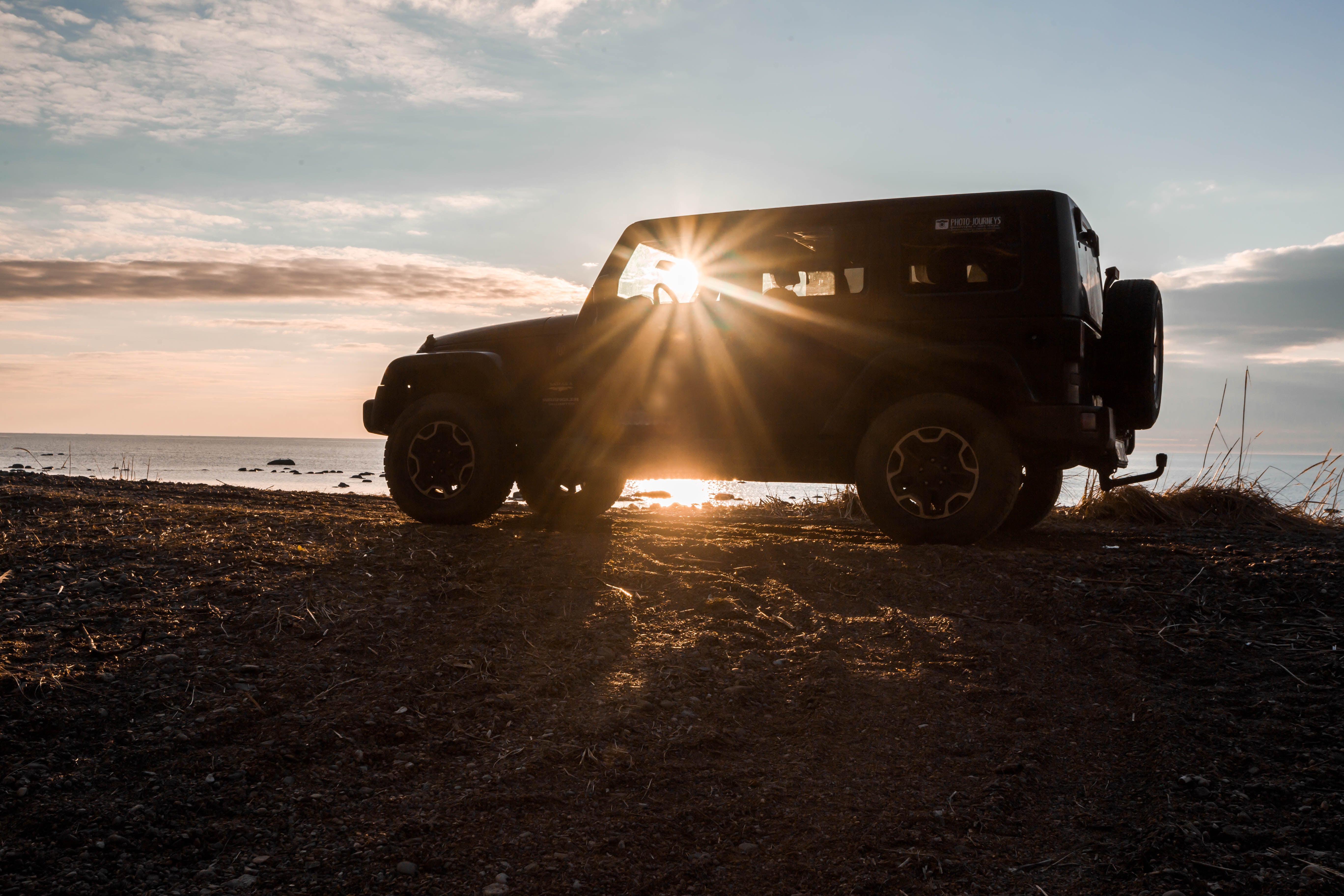 Silhouette of a jeep in the sun